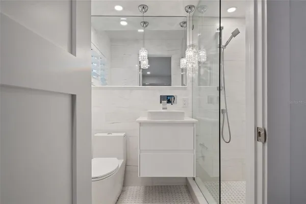 a bathroom with a shower a toilet and a sink