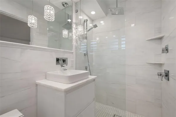 a bathroom with a sink toilet and shower