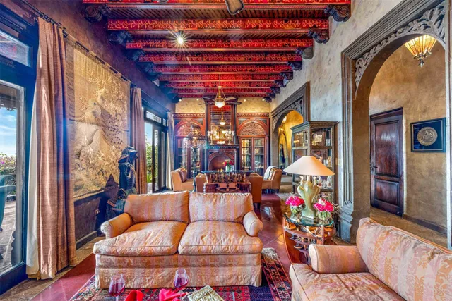 a view of a dining room with furniture a chandelier and wooden floor