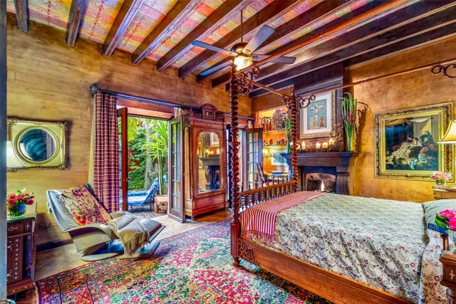 a view of a yard with plants and large trees