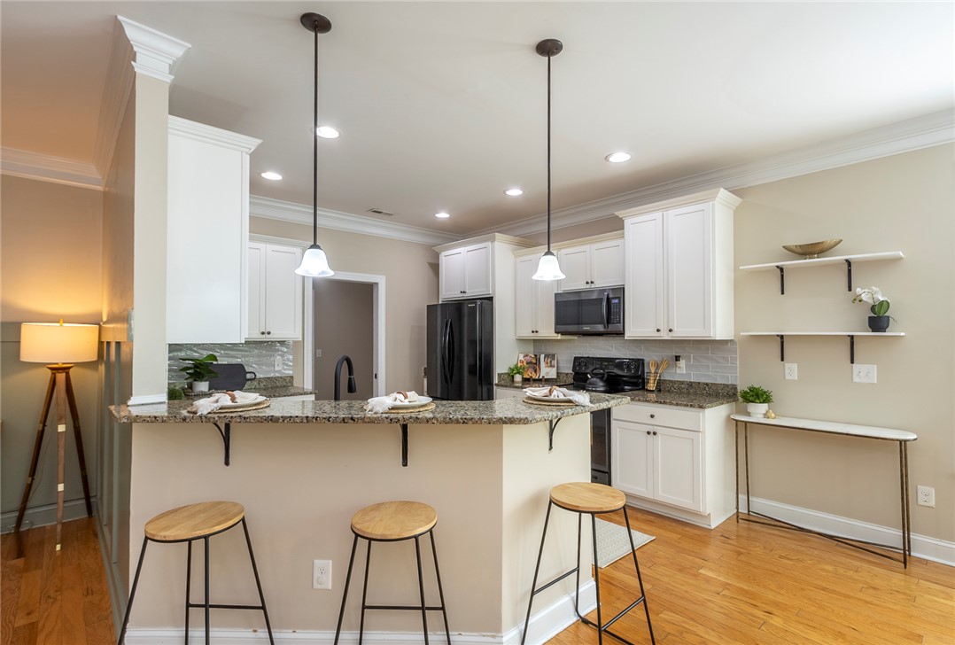234 Streams Way Anderson, SC 29625 - Photo 34 of 44 This bright kitchen features modern appliances, granite counters, and hardwood flooring.