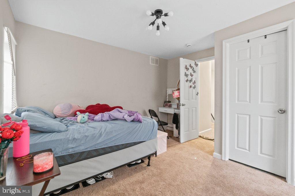 701 Baker Street Baltimore, MD 21217 - Photo 20 of 26 a bedroom with a bed and cabinets