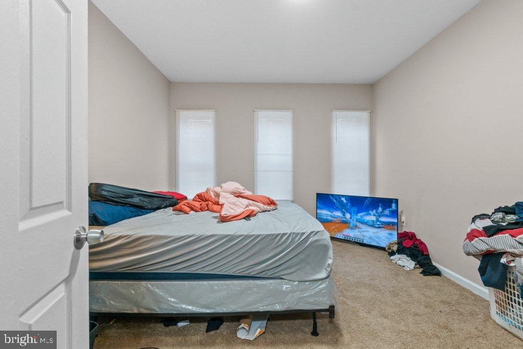 701 Baker Street Baltimore, MD 21217 - Photo 25 of 26 a bedroom with a bed and a window
