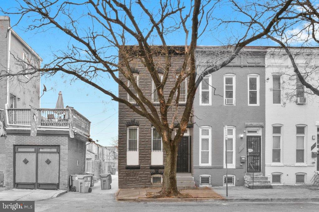 701 Baker Street Baltimore, MD 21217 - Photo 4 of 26 a front view of a building with large trees