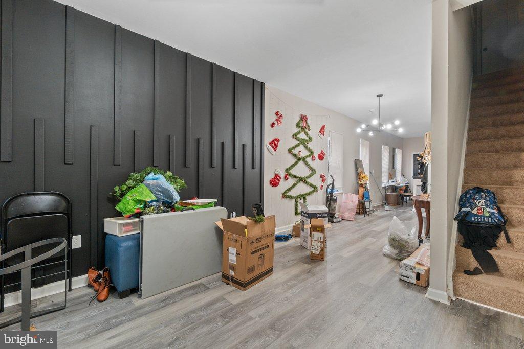 701 Baker Street Baltimore, MD 21217 - Photo 7 of 26 a living room with furniture and a chandelier