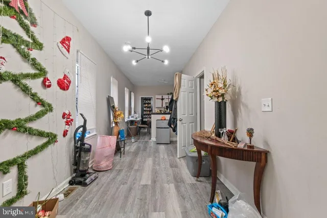 a view of a room with gaming equipment and wooden floor