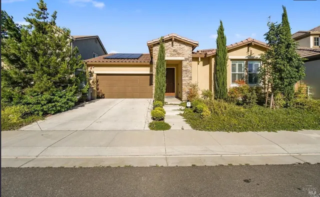 a front view of a house with trees