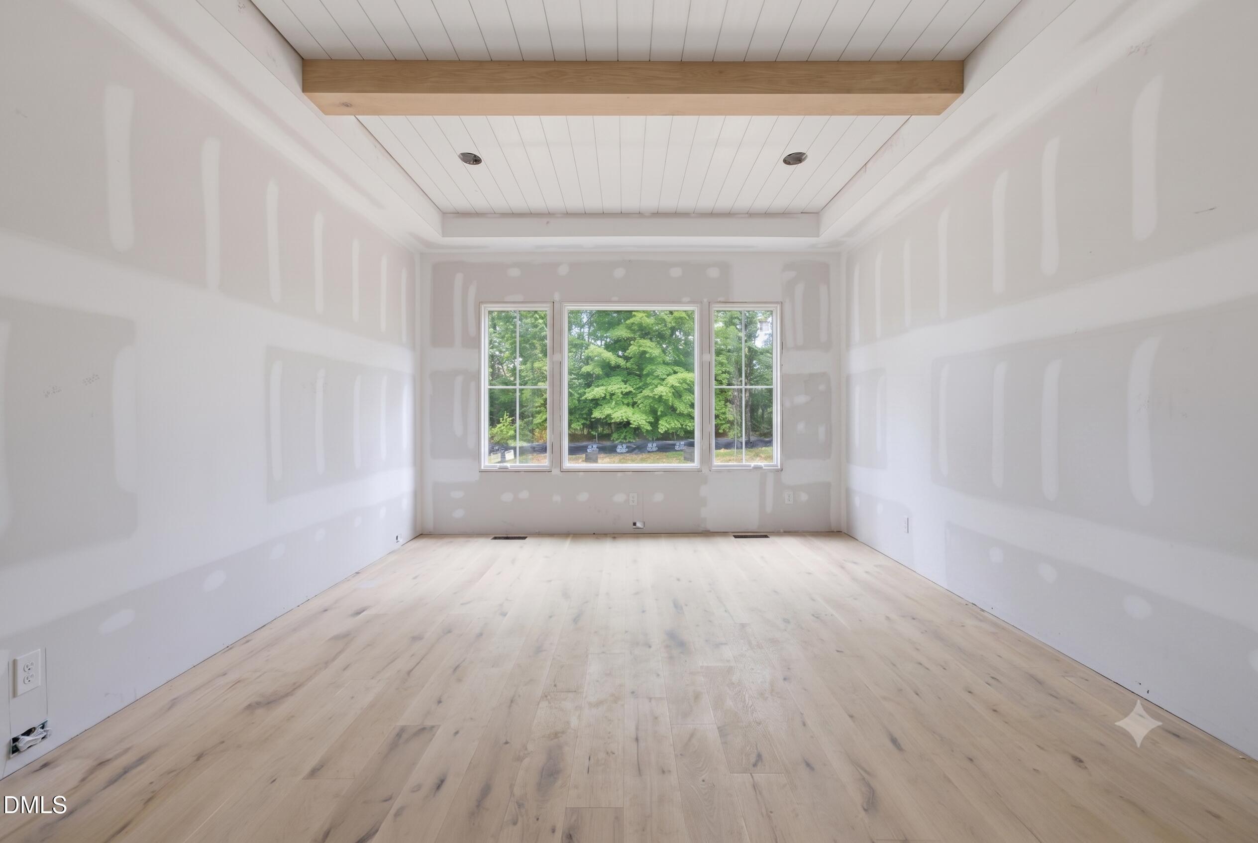 7508 Grist Mill Road Raleigh, NC 27615 - Photo 8 of 32 a view of an empty room with wooden floor and a window