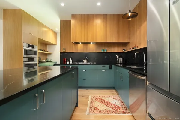 a kitchen with a refrigerator and a sink