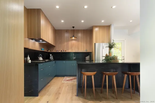 a kitchen with kitchen island granite countertop a table and chairs in it