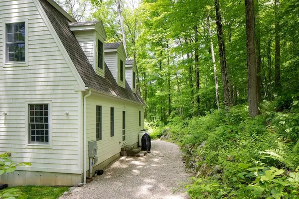 a view of a house with lots of trees and plants