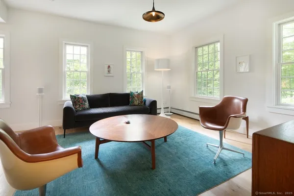 a living room with furniture a window and a lamp
