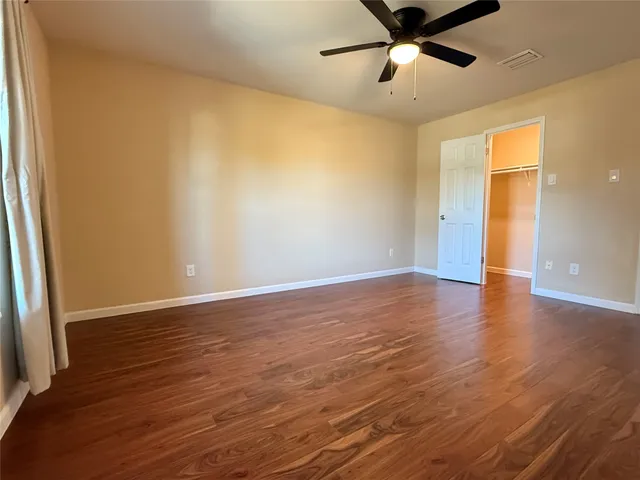 a bathroom with a granite countertop sink a toilet a mirror and shower