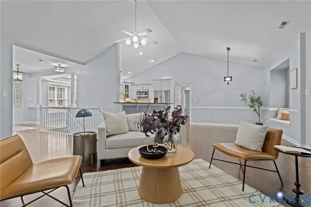 a living room with furniture and a chandelier