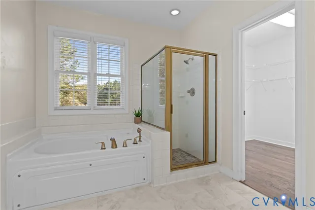 a bathroom with a bathtub and a shower