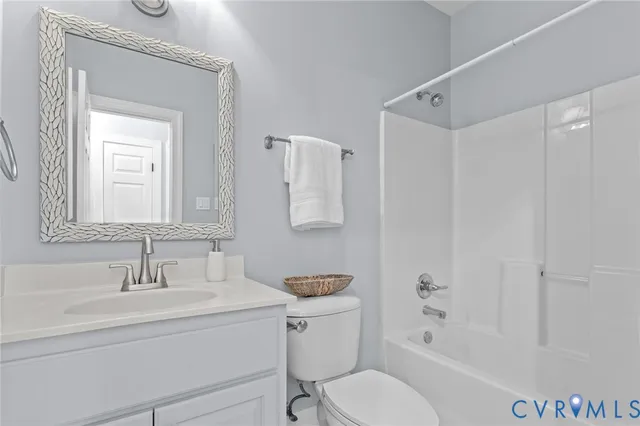 a bathroom with a granite countertop sink toilet a mirror and shower