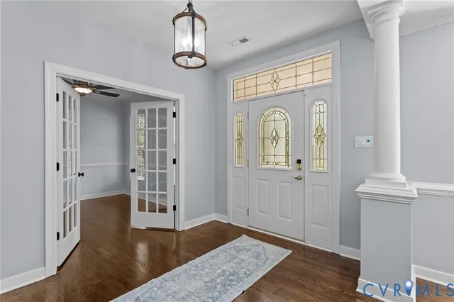 a view of a hallway with wooden floor and closet