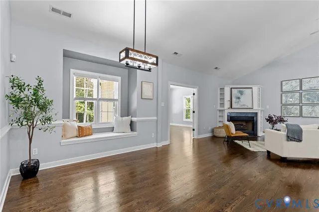 a living room with furniture window and potted plants