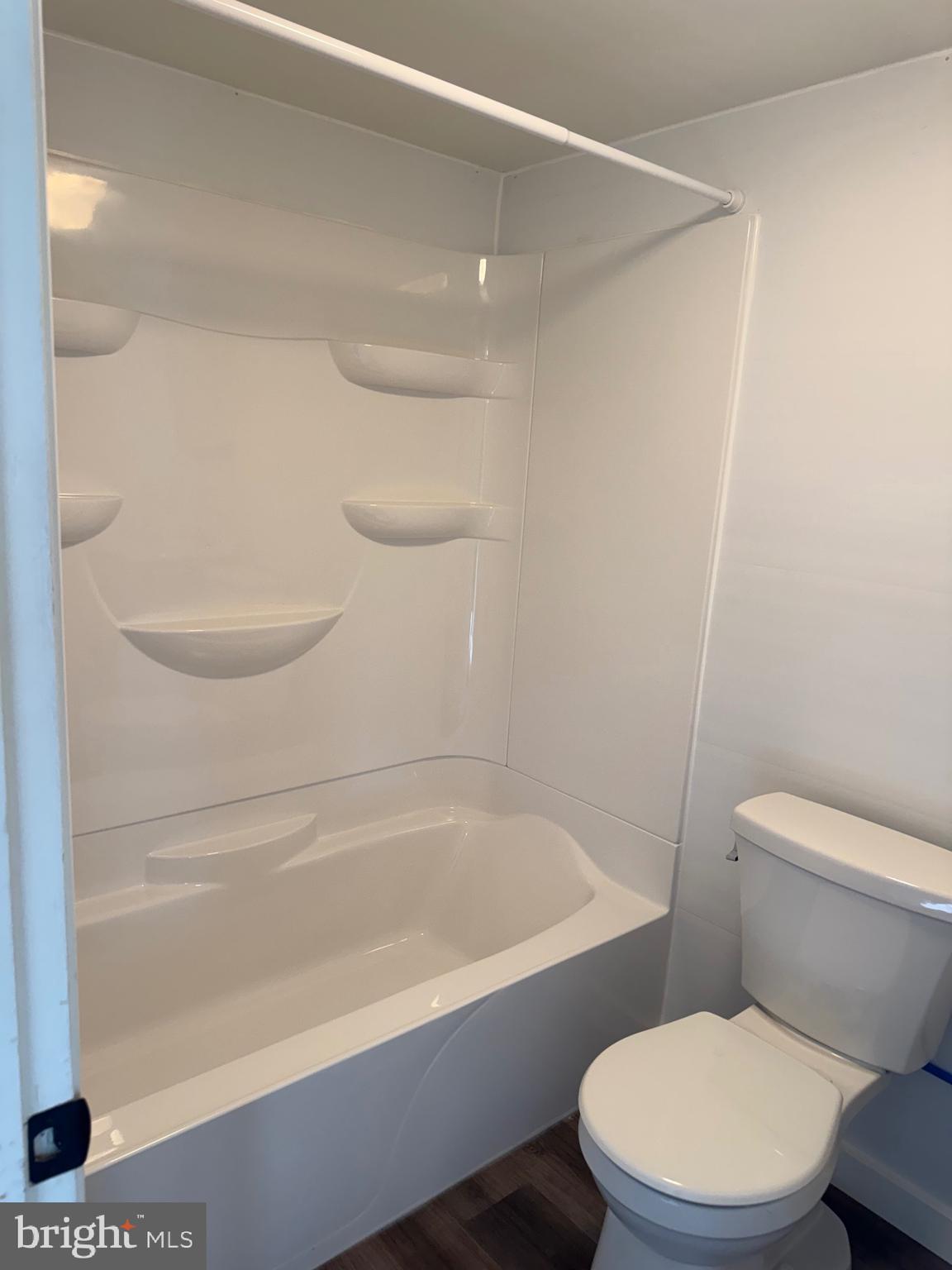 356 Keneagy Hill Road, Unit 20 Ronks, PA 17572 - Photo 7 of 7 a white toilet sitting next to a bath tub