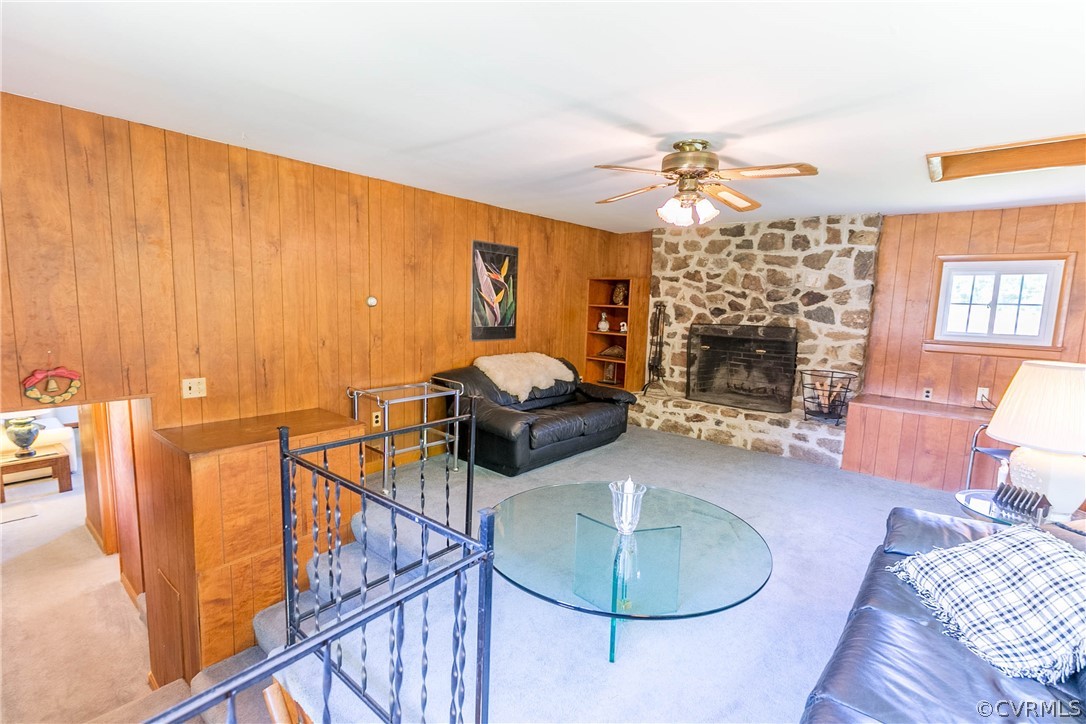 7339 Strath Road Henrico, VA 23231 - Photo 29 of 50 a living room with furniture a fireplace and a chandelier