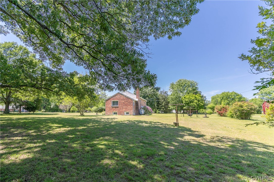 7339 Strath Road Henrico, VA 23231 - Photo 45 of 50 a view of a house with a big yard and large trees