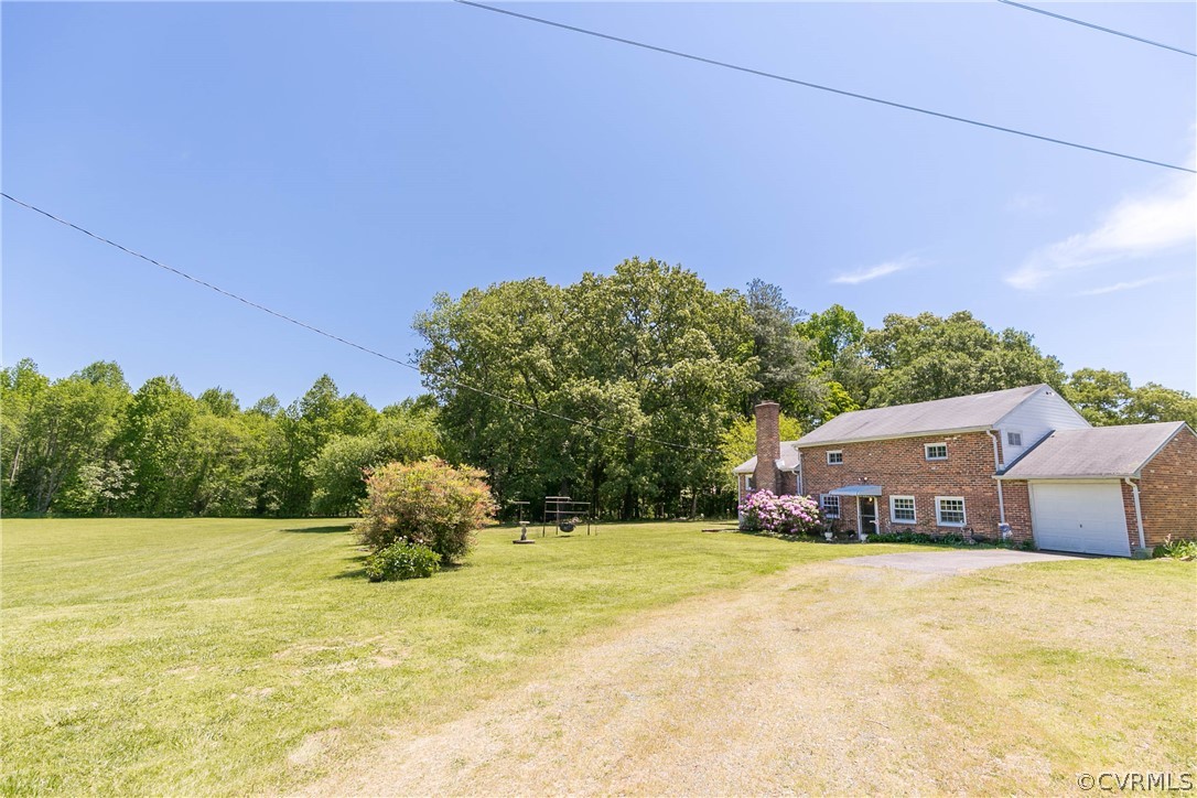 7339 Strath Road Henrico, VA 23231 - Photo 48 of 50 a yellow house with trees in the background