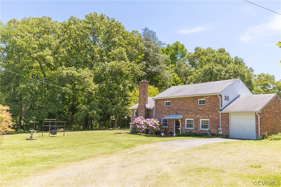 7339 Strath Road Henrico, VA 23231 - Photo 49 of 50 a front view of a house with a yard and trees