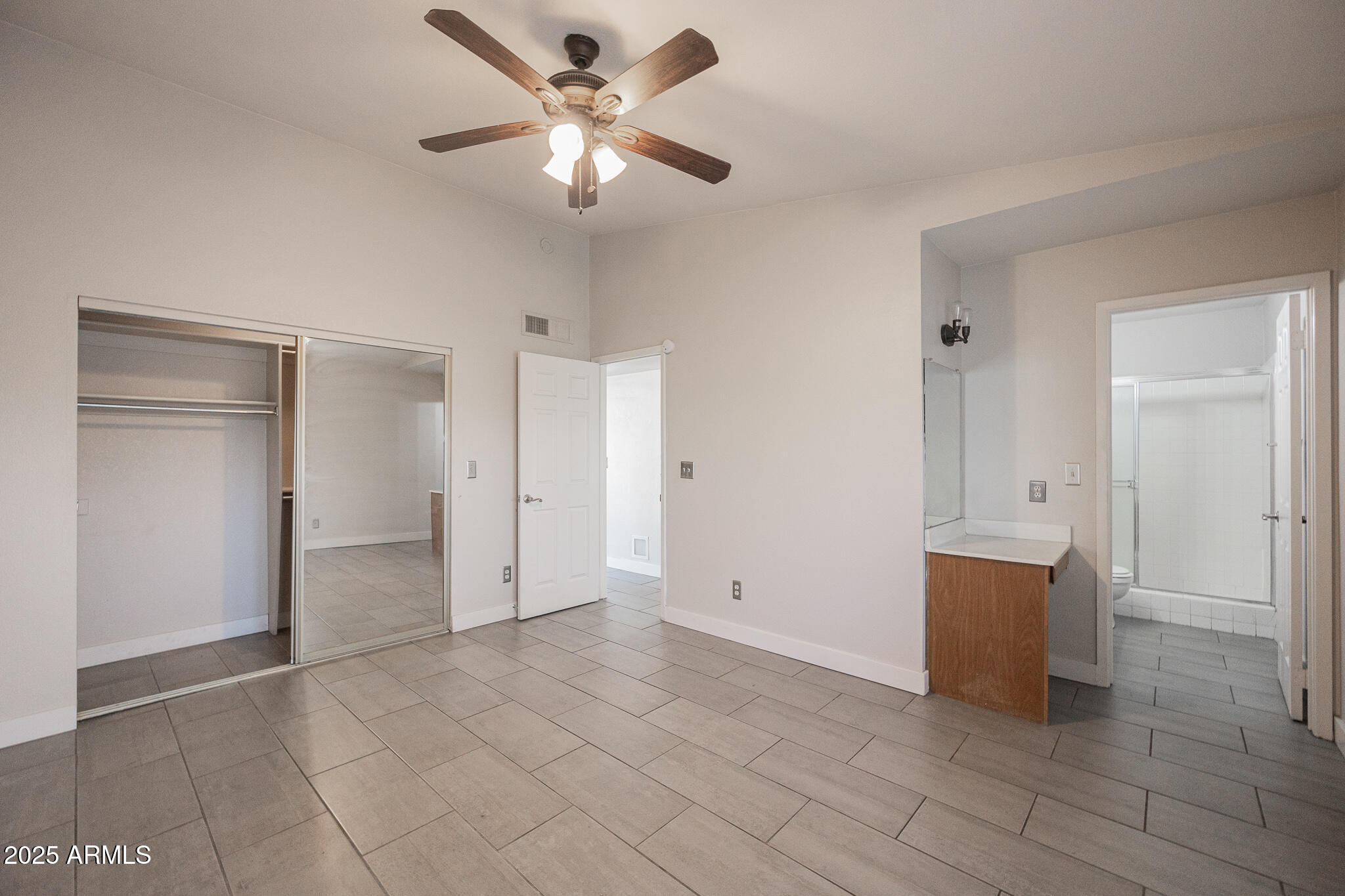 1025 West Laguna Drive Tempe, AZ 85282 - Photo 11 of 20 an empty room with closet and windows