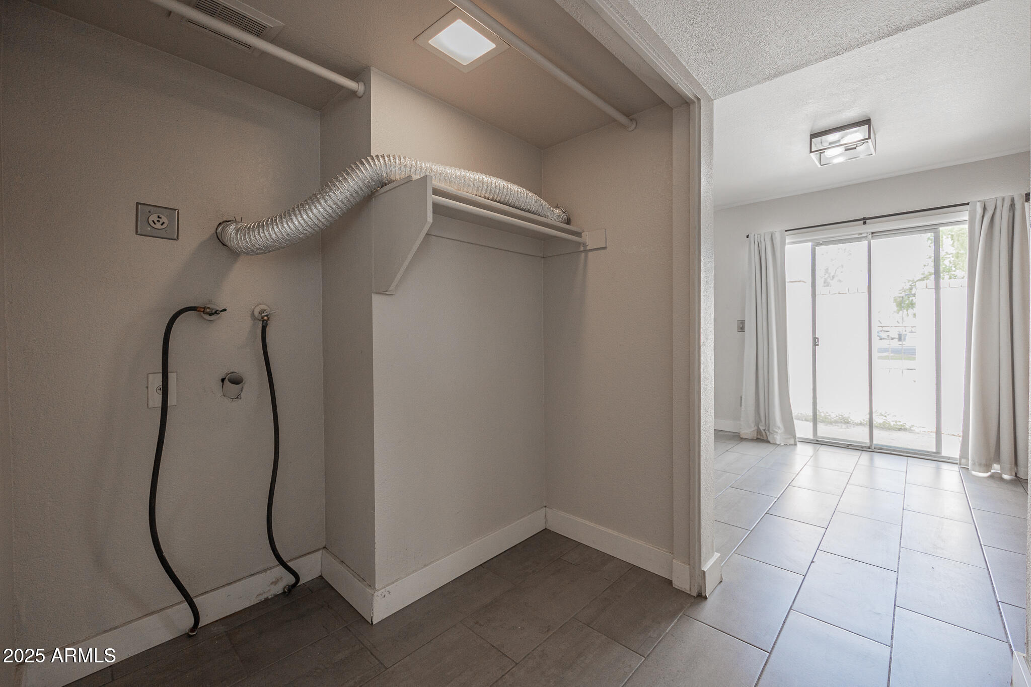 1025 West Laguna Drive Tempe, AZ 85282 - Photo 18 of 20 a view of a room with rack and white walls