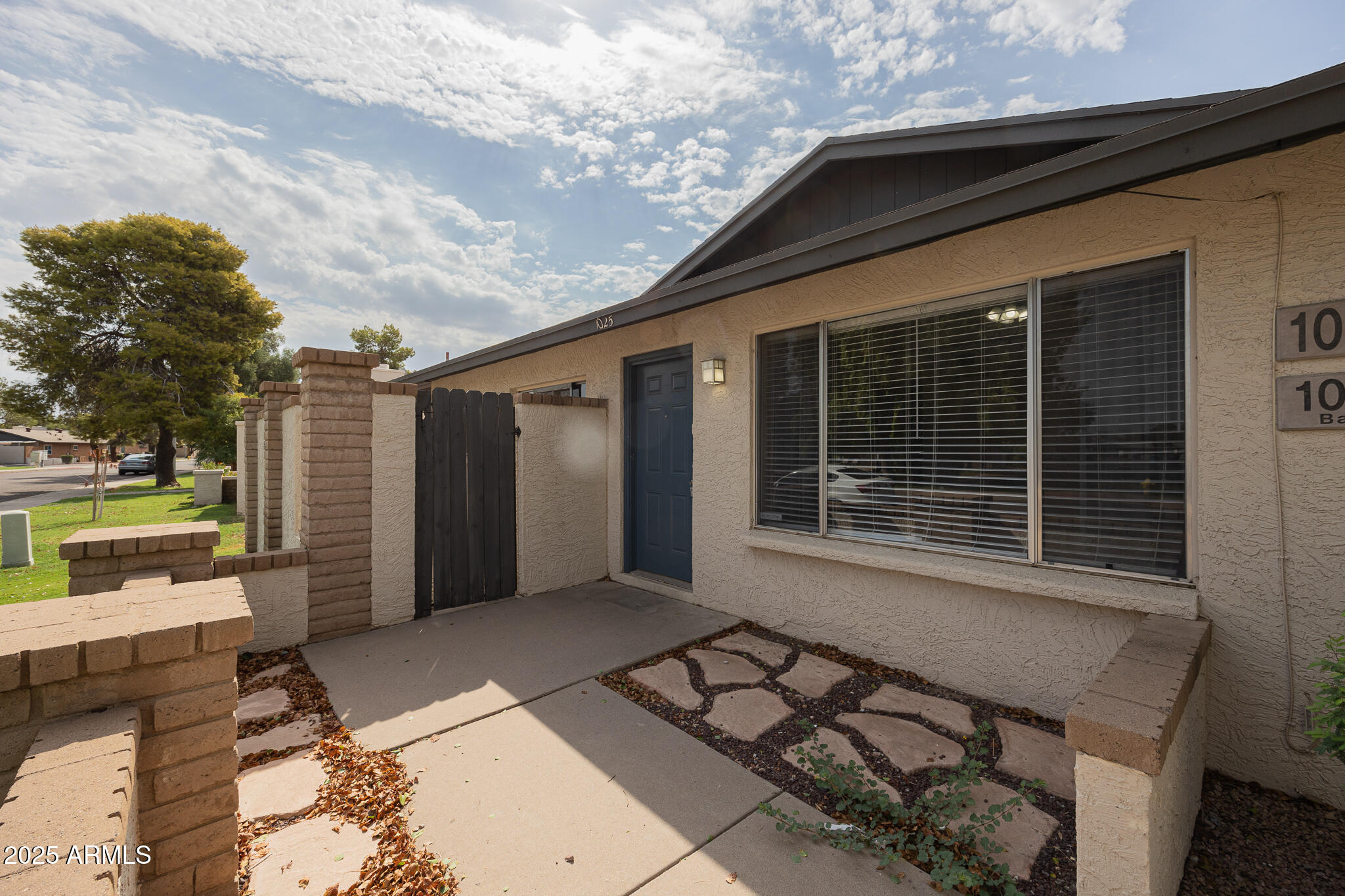 1025 West Laguna Drive Tempe, AZ 85282 - Photo 3 of 20 a front view of a house with garden