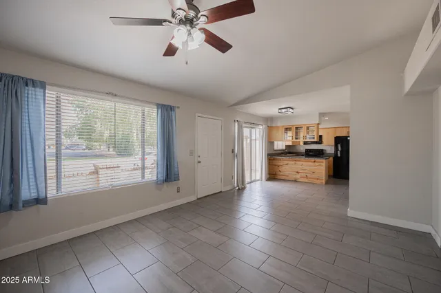 a view of empty room with cabinet and window