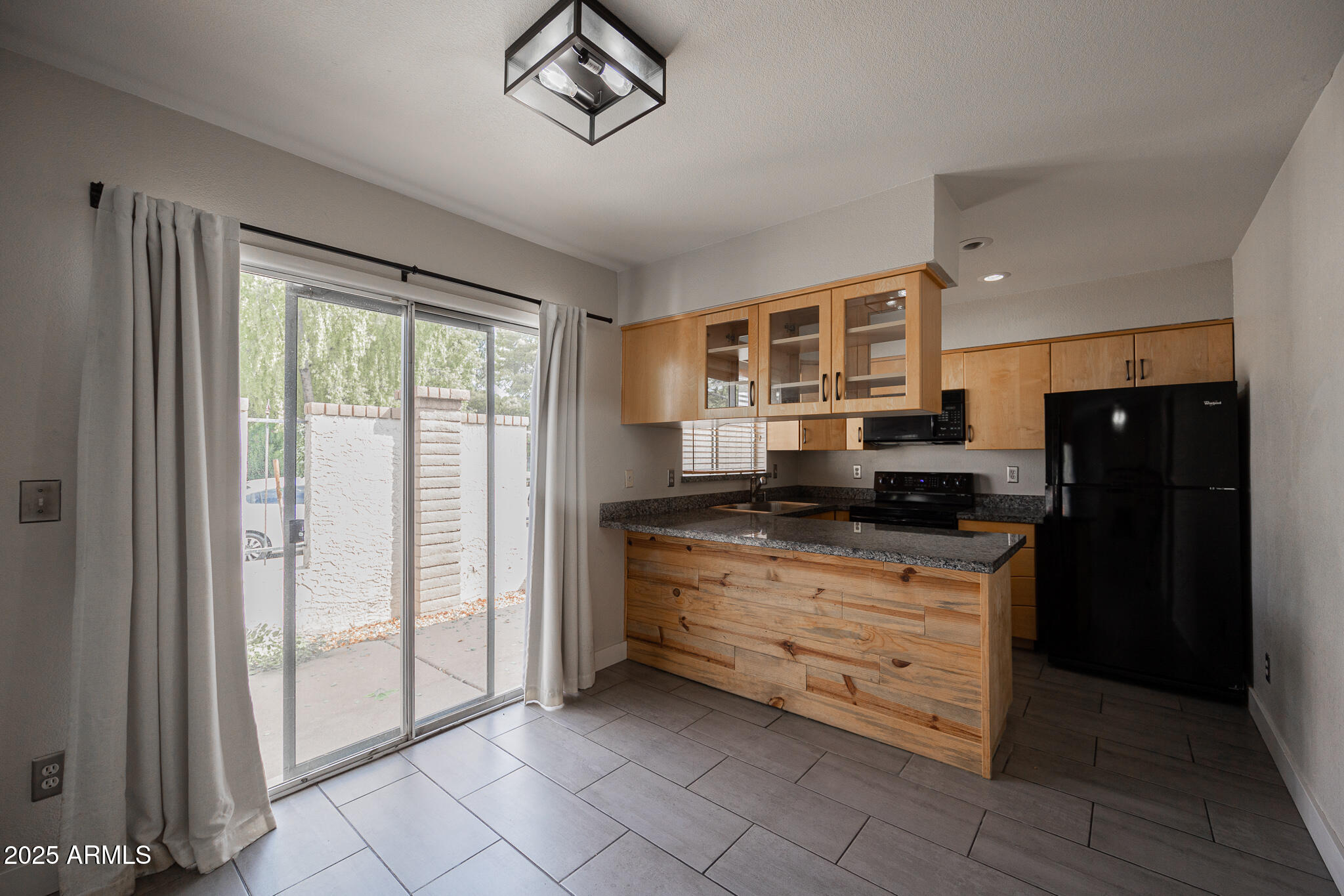 1025 West Laguna Drive Tempe, AZ 85282 - Photo 8 of 20 a kitchen with granite countertop a refrigerator and a sink