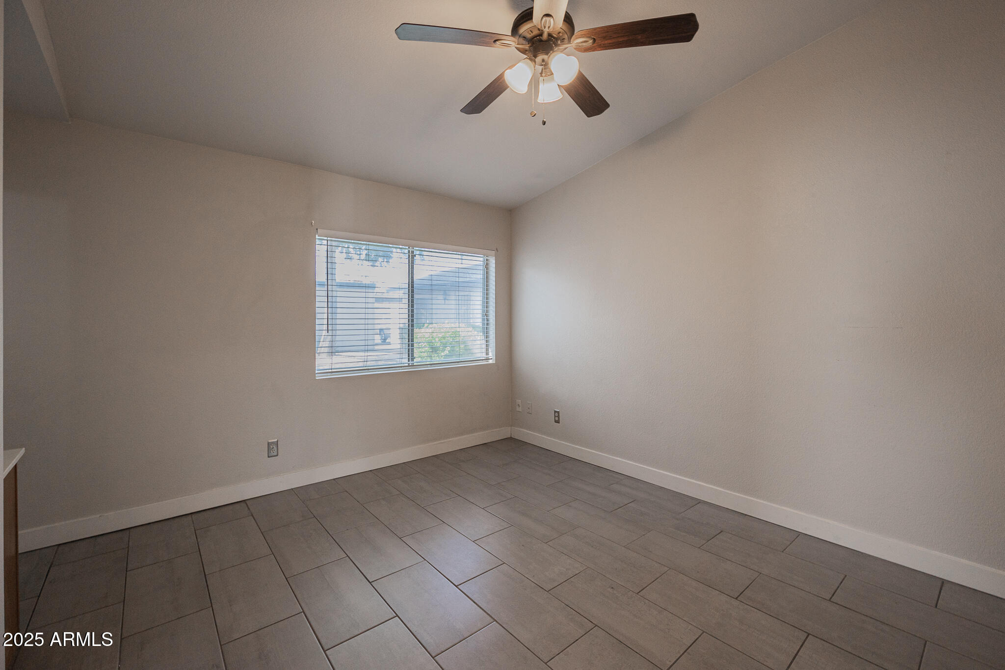 1025 West Laguna Drive Tempe, AZ 85282 - Photo 10 of 20 an empty room with windows and fan