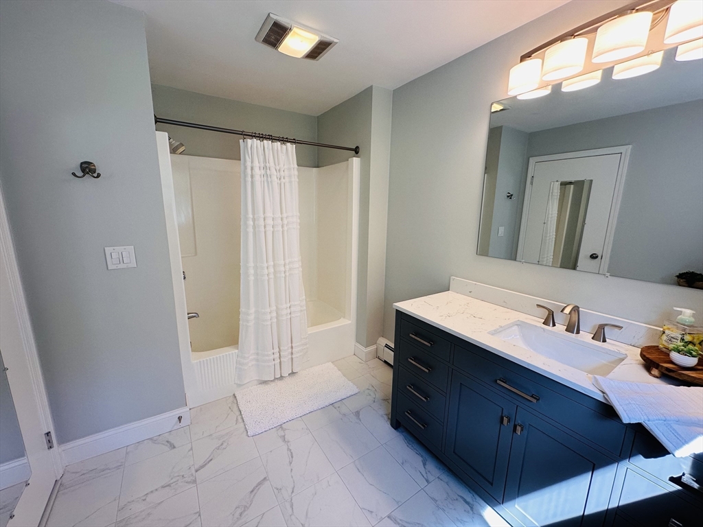 1107 Jackson Road Hardwick, MA 01037 - Photo 12 of 41 a spacious bathroom with a double vanity sink and a mirror
