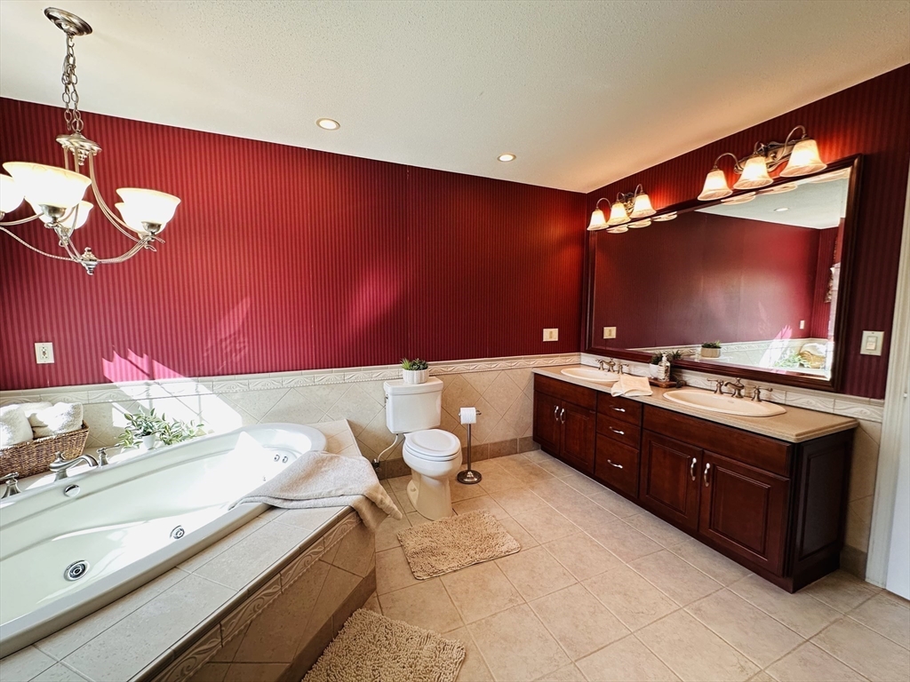 1107 Jackson Road Hardwick, MA 01037 - Photo 26 of 41 a spacious bathroom with a sink a mirror and a lamp