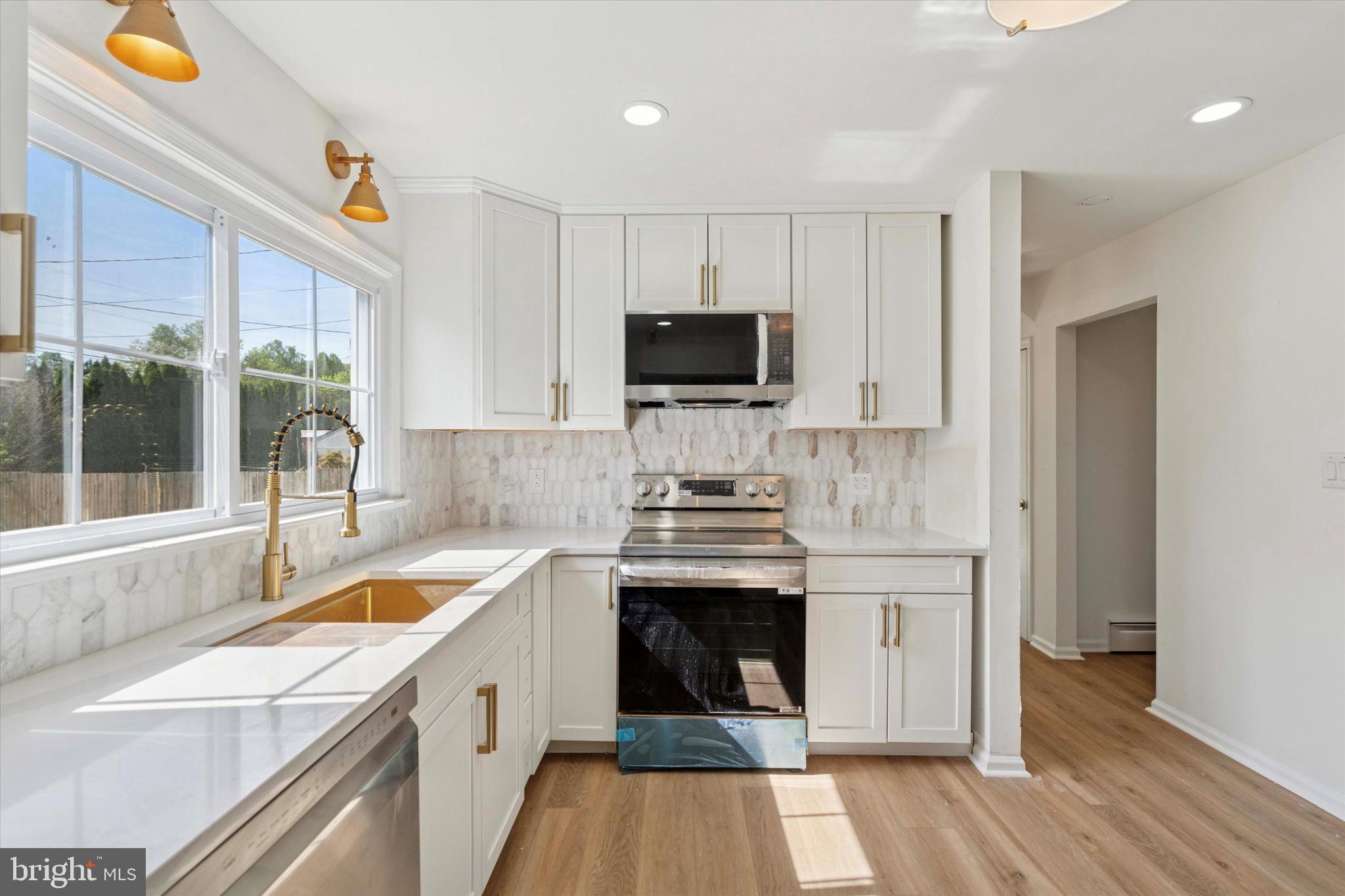 227 Spohn Road Reading, PA 19608 - Photo 5 of 21 a kitchen with a sink and a stove top oven