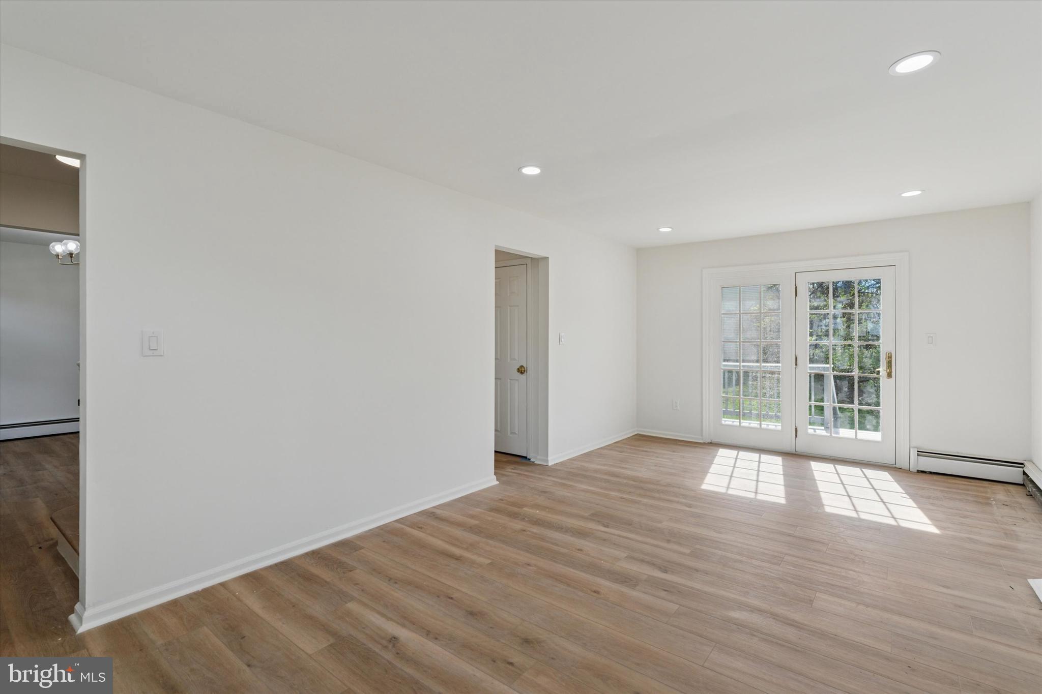 227 Spohn Road Reading, PA 19608 - Photo 6 of 21 a view of an empty room with wooden floor and a window