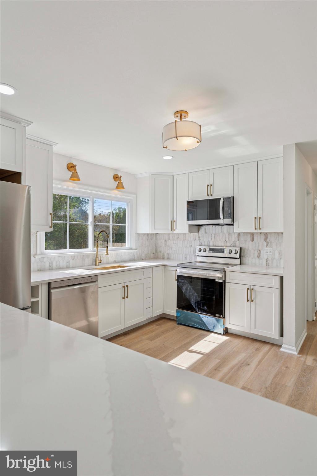 227 Spohn Road Reading, PA 19608 - Photo 9 of 21 a kitchen with stainless steel appliances a white cabinets and a stove top oven
