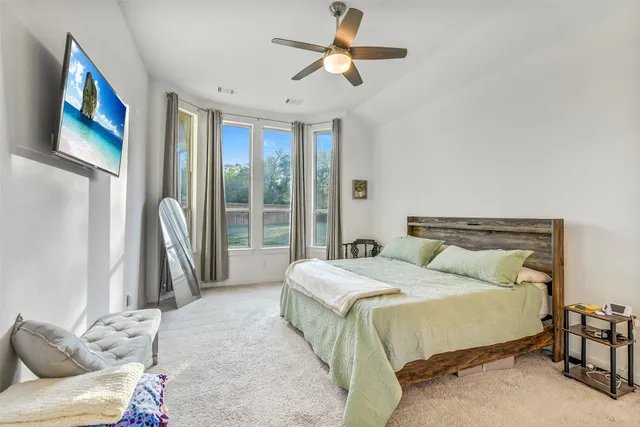 a bedroom with a bed and a painting on the wall