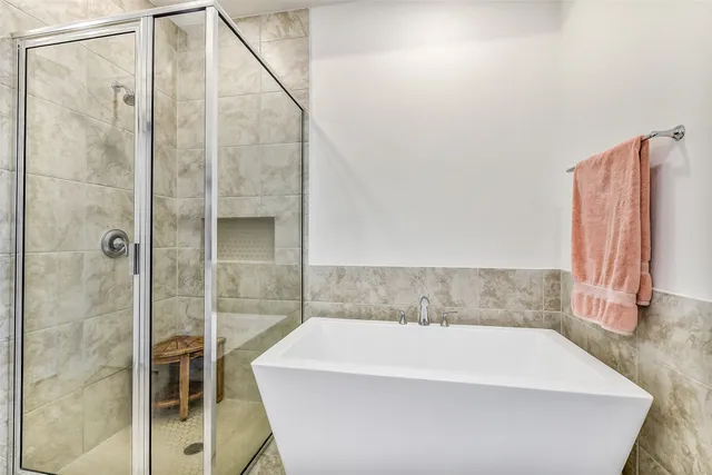 a bathroom with a bathtub and a shower