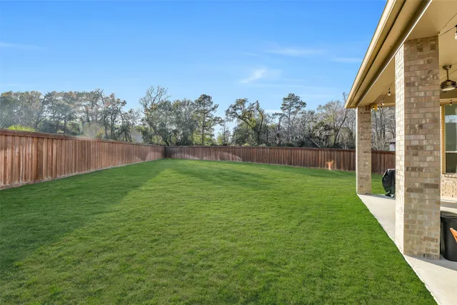 a view of yard with grass and trees