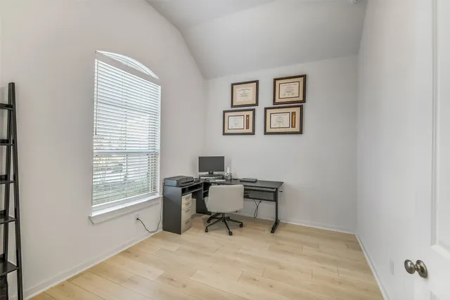 a workspace with white wall and a window