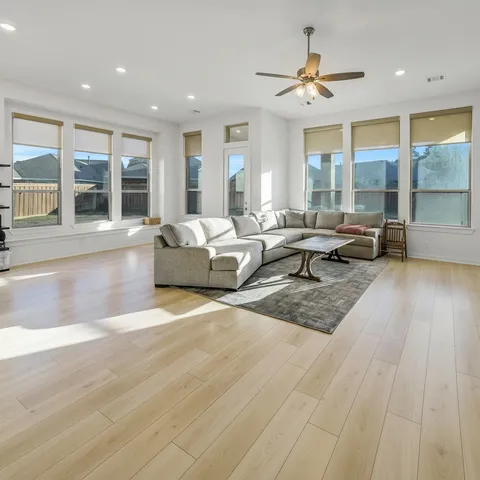 a living room with furniture and large windows