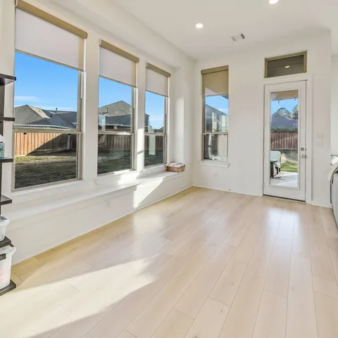 a view of an entryway with wooden floor and door