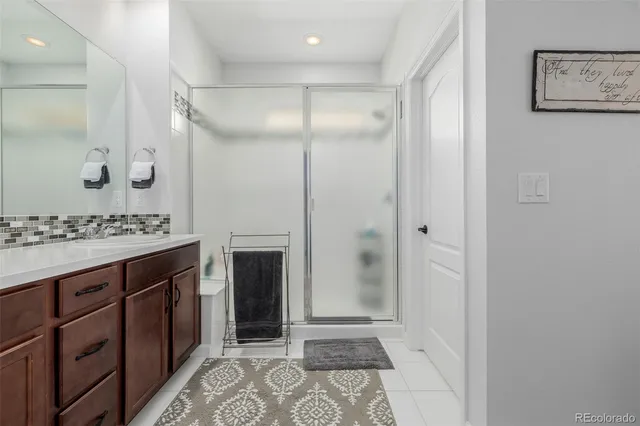 a bathroom with a shower sink and a mirror