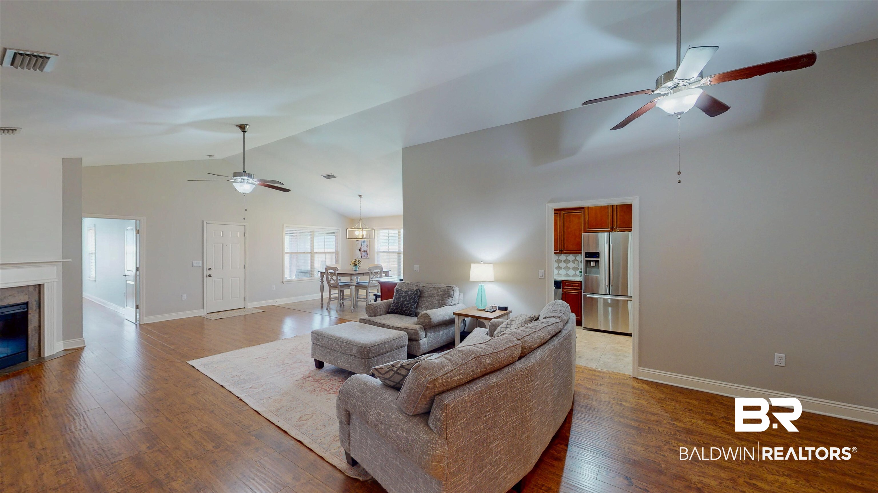 1704 Arcadia Drive Foley, AL 36535 - Photo 11 of 52 Living room featuring ceiling fan, wood finished floors, high vaulted ceiling, and a high end fireplace