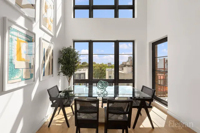 a kitchen with stainless steel appliances granite countertop a stove a refrigerator a sink a dining table and chairs with wooden floor