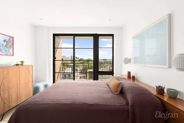 a bedroom with a large bed and a large window