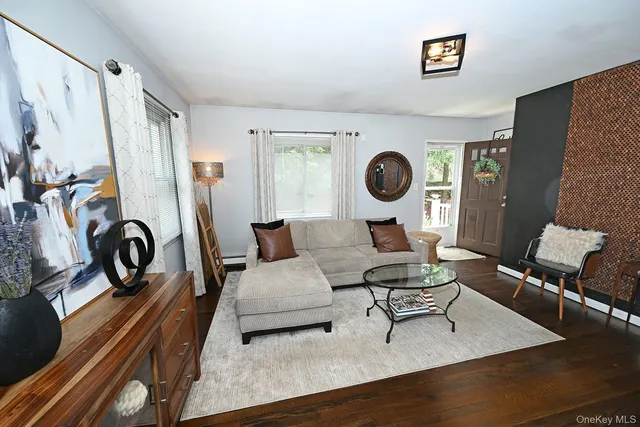 a living room with furniture a rug and a large window