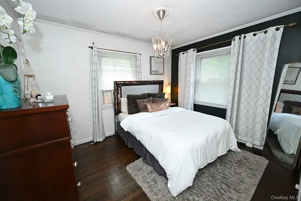 a bedroom with a bed and a mirror